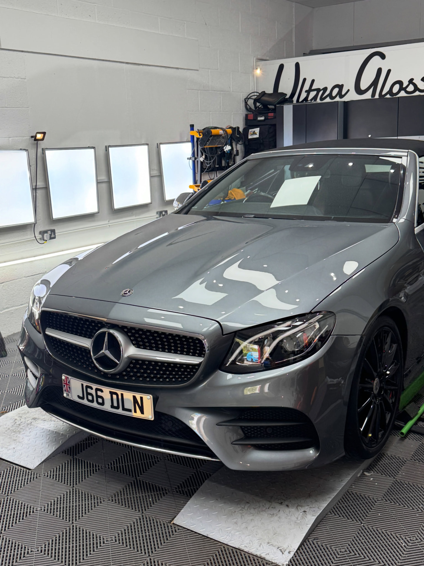 Grey Mercedes under inspection lights in the Ultra Gloss studio